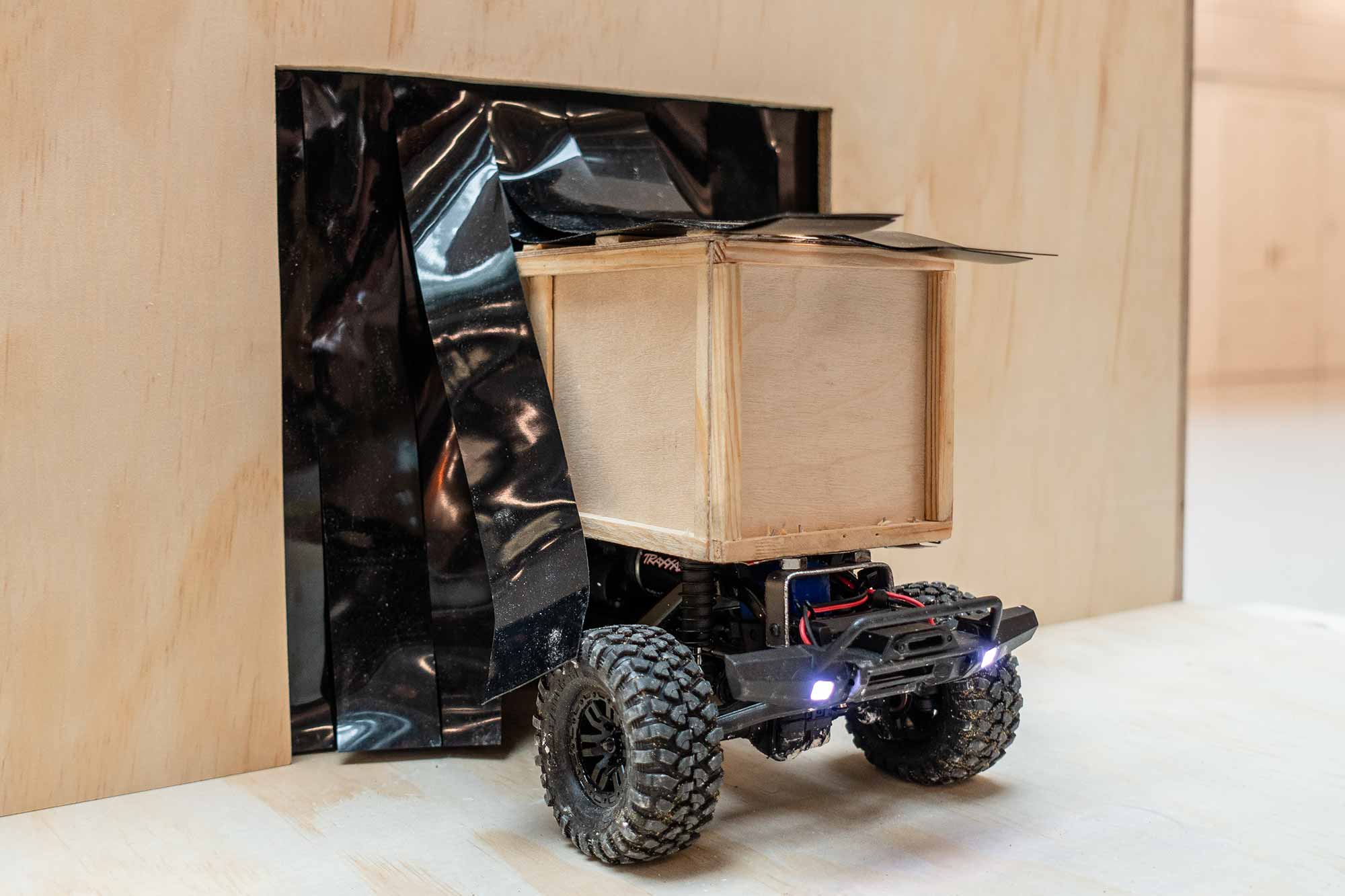 a rc-car coming out of a wooden box