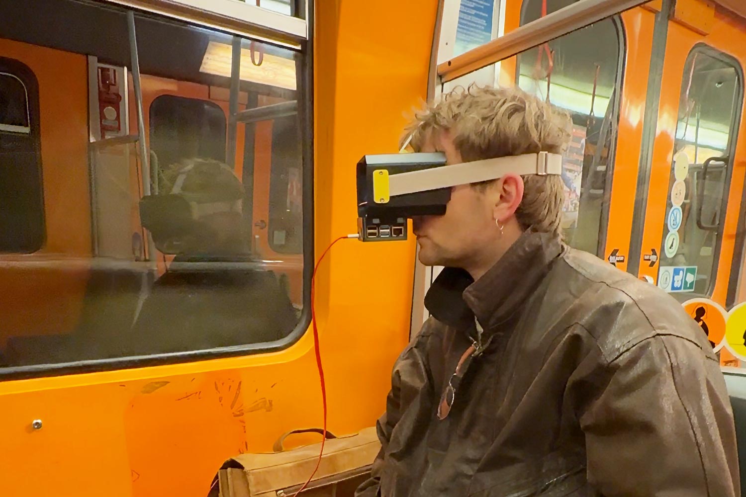 man in a subway wears makeshift x-ray headset