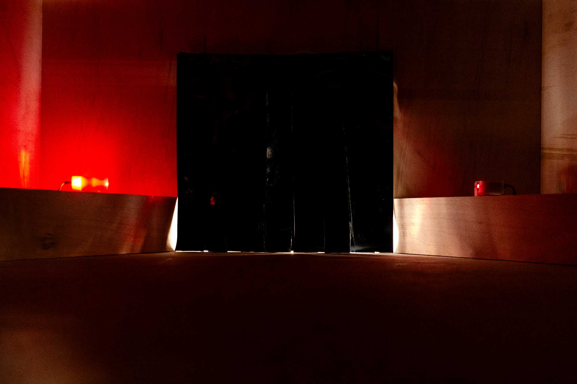 the inside of a wooden box illuminated with red lights