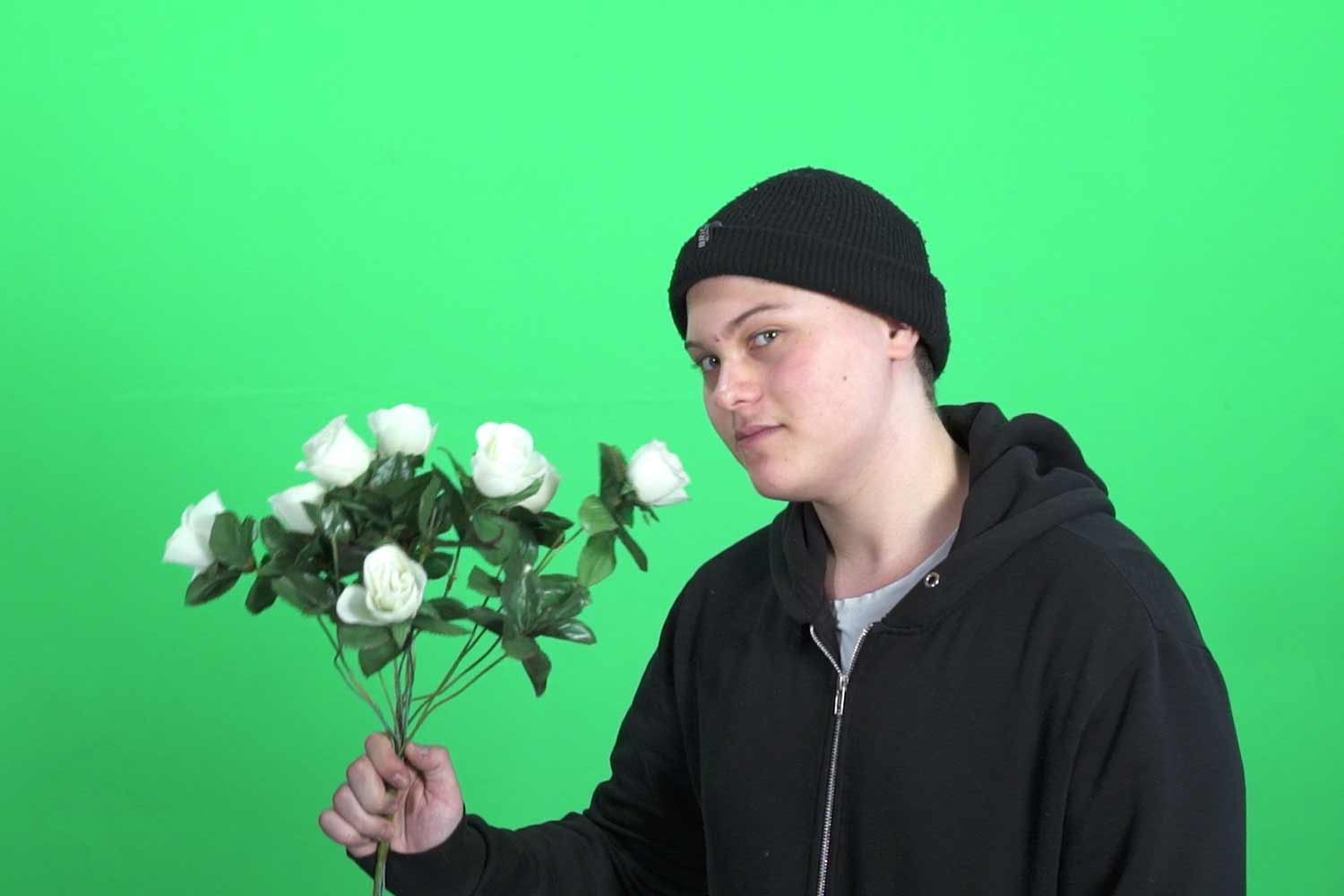 green screen and guy with flowers