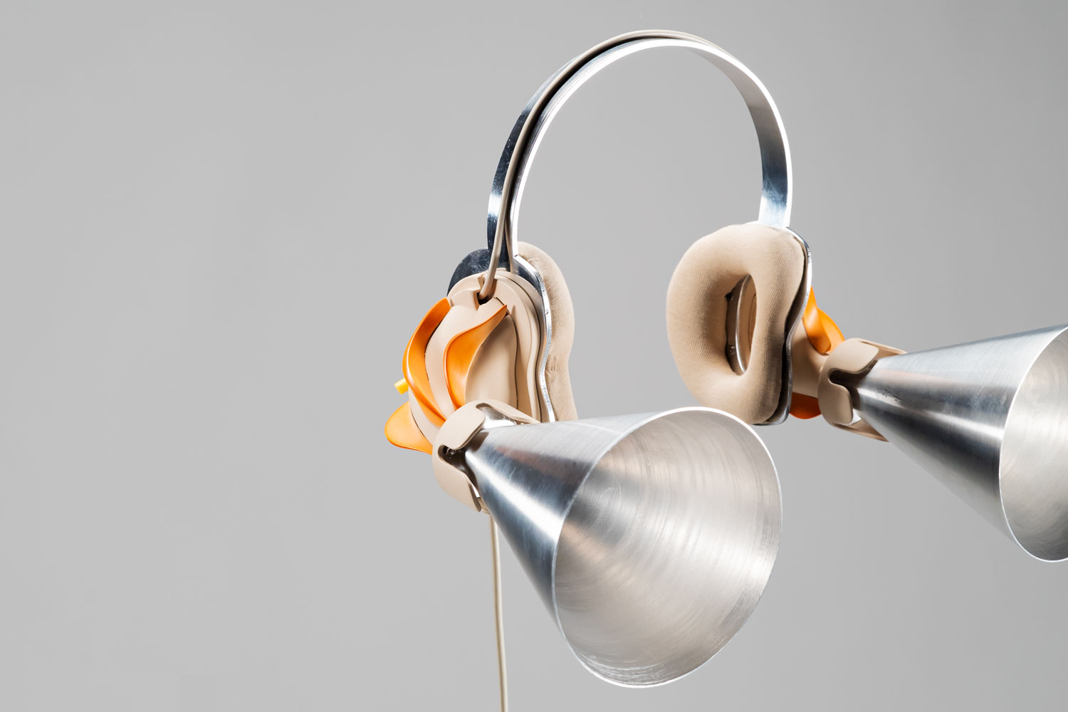 photo of a headphone-looking piece with metall funnels
