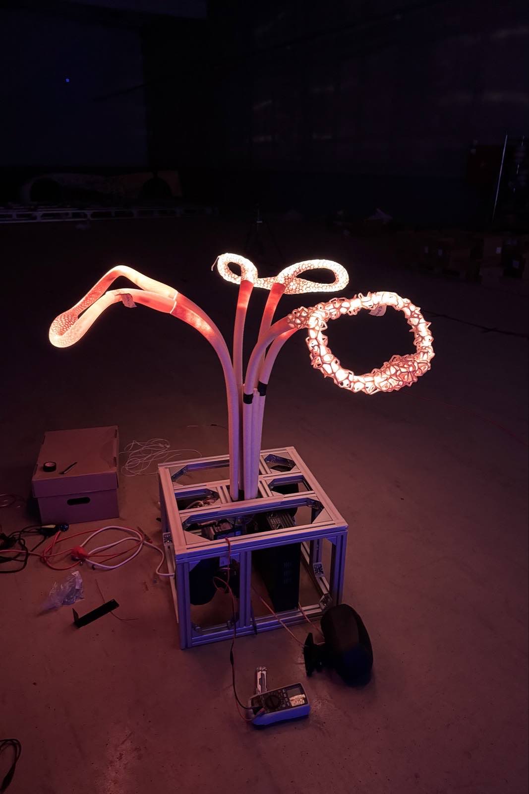 Behind the scenes of physical prototype on a desk, glowing with warm light.