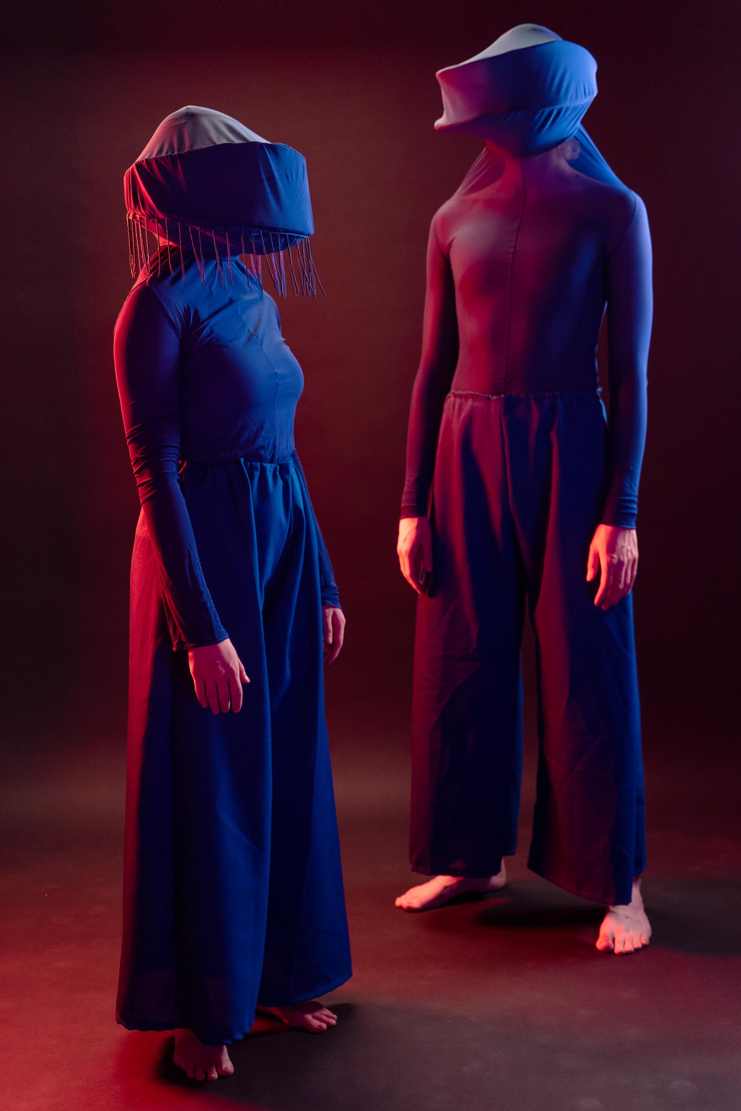 Two blue costumes in a ambient-lit photostuido