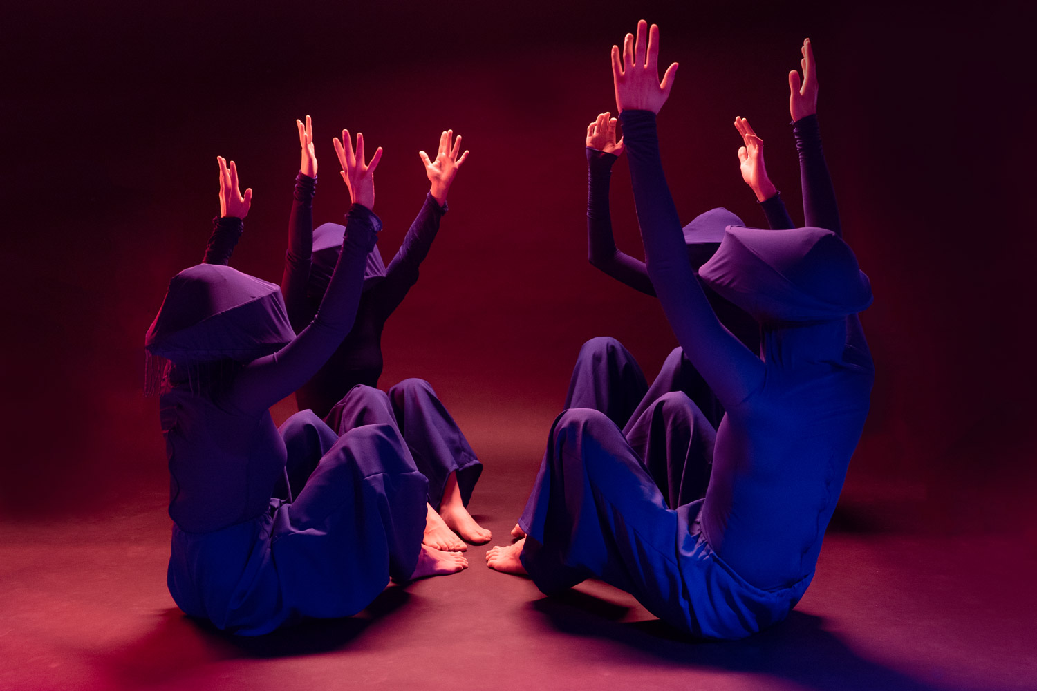 Four members of a fictional religion sitting in a circle