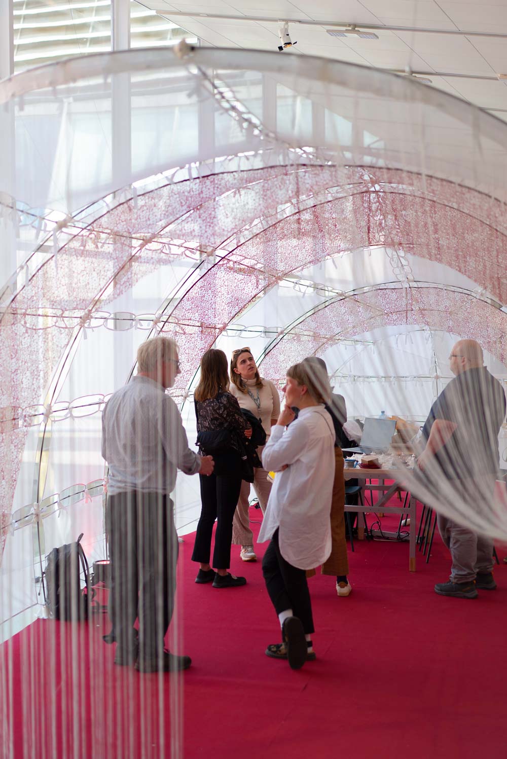 Interior exhibition view showing whale and persons